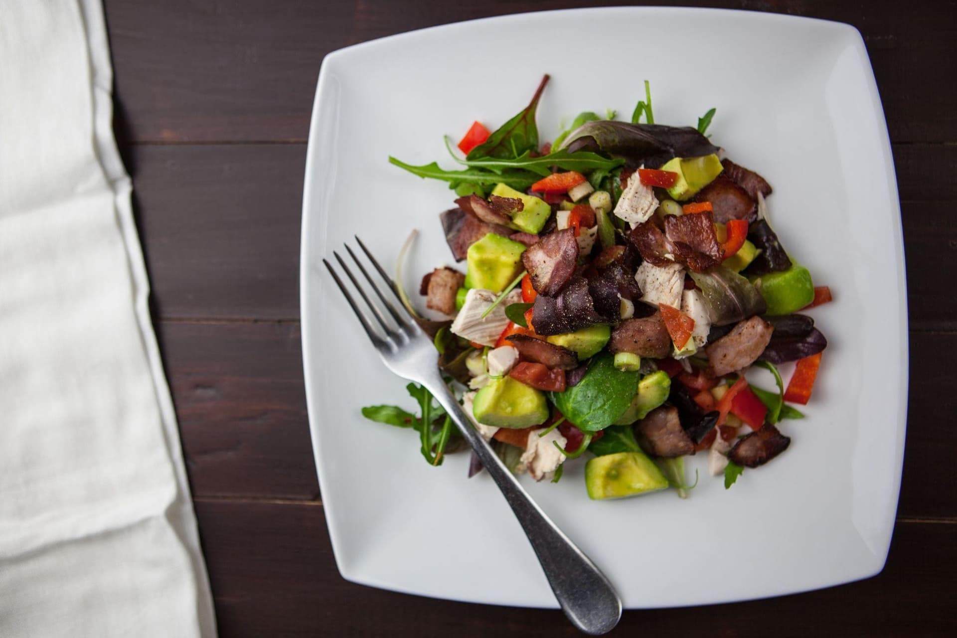 Paleo meal plan ingredients including healthy fats, greens, and proteins