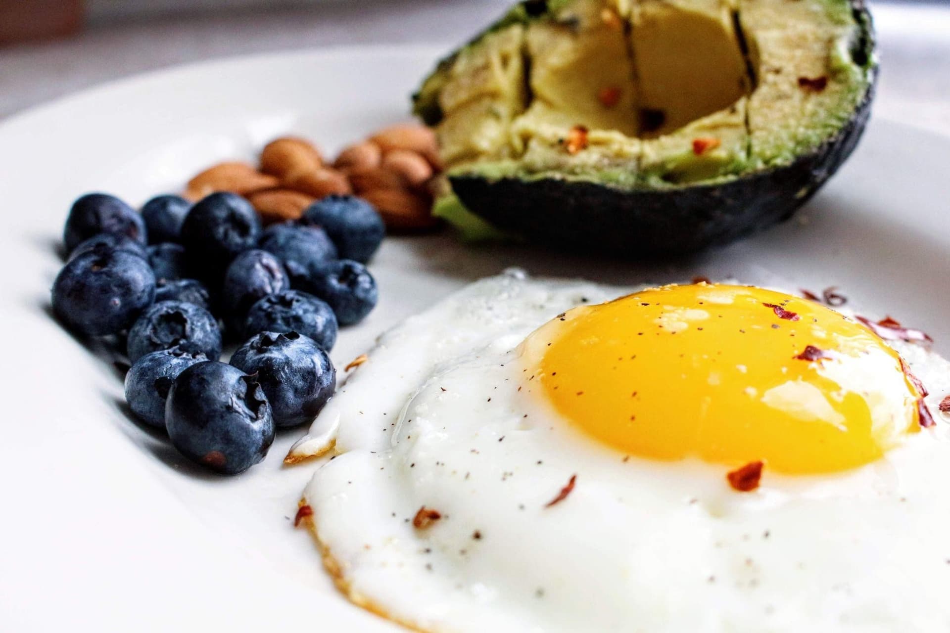 Keto diet foods including avocado, eggs, salmon and healthy fats